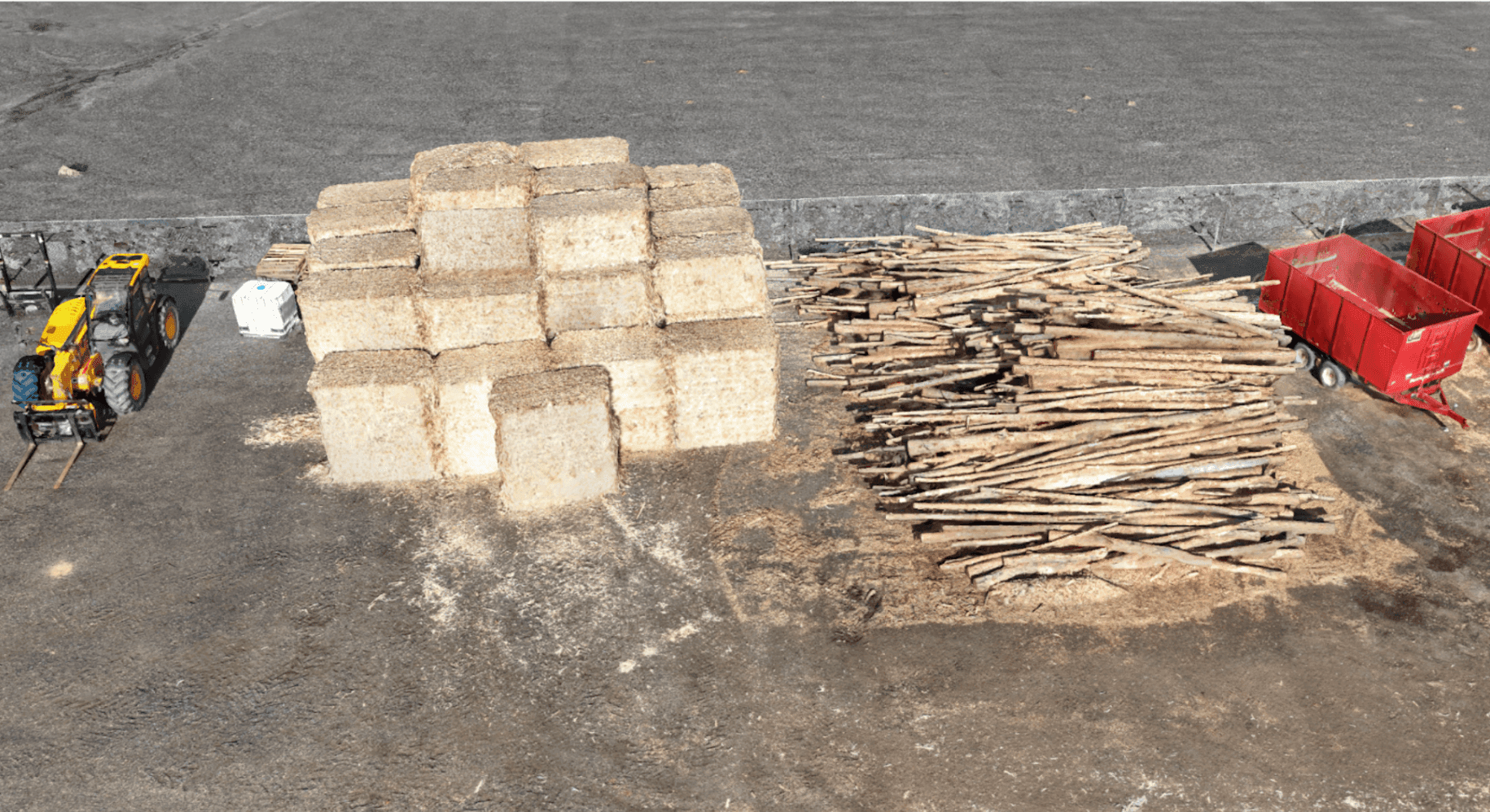 Aerial view of biomass storage yard with irregular piles