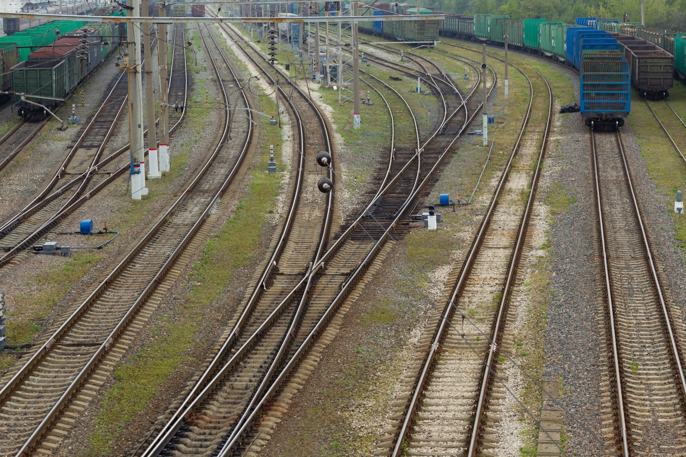 Rail switch yard with diverging tracks and staged freight cars
