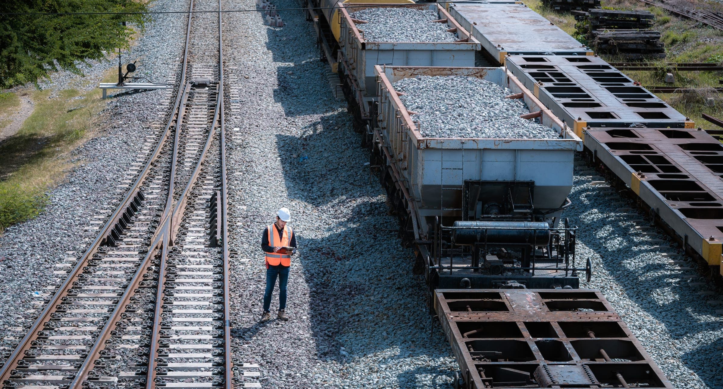 Field worker at a rail-served bulk site during a hardware deployment