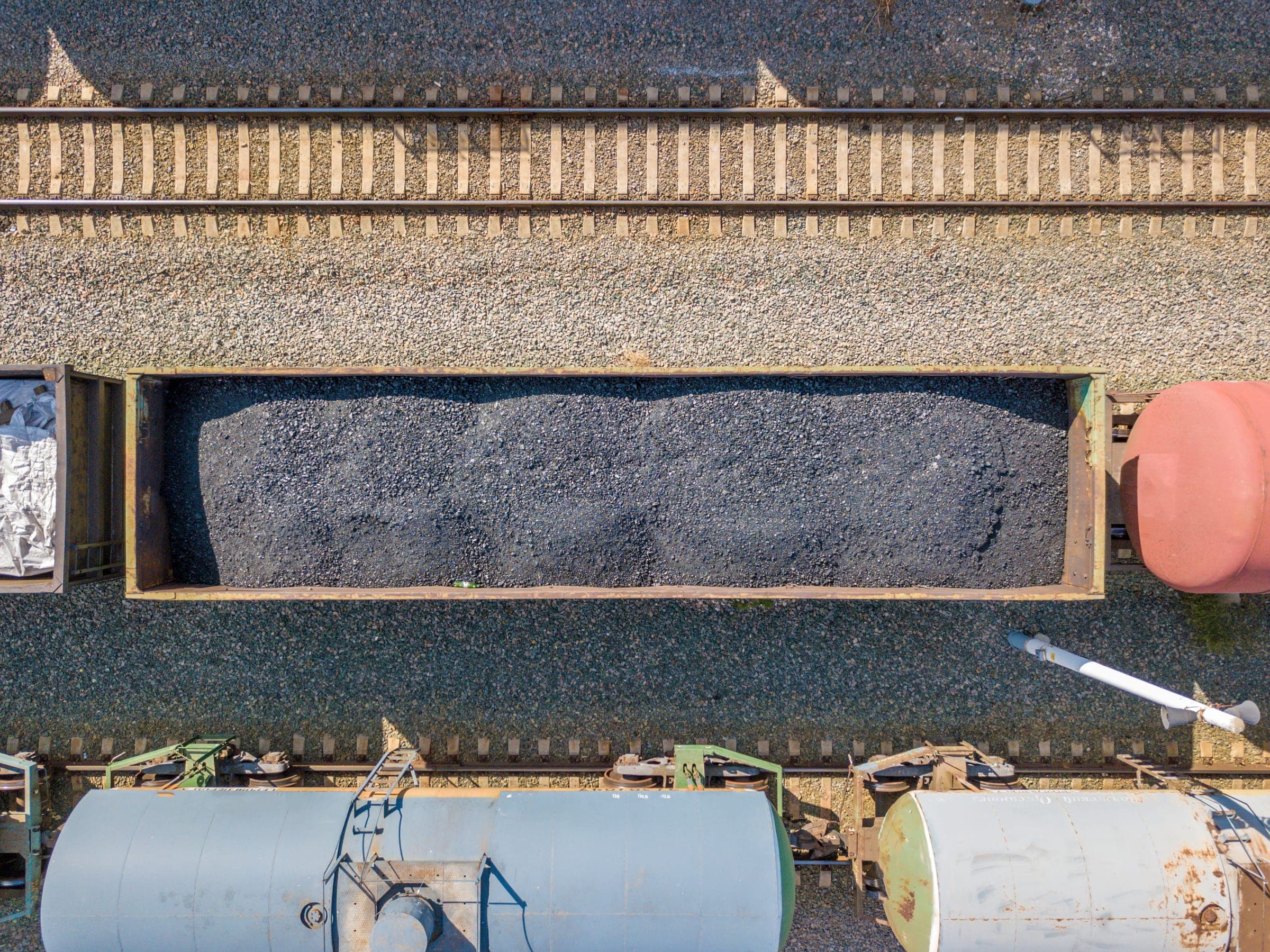 Aerial view of trucks and railcars being loaded with dry bulk material at a terminal